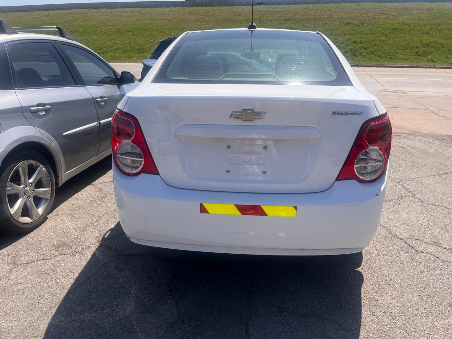 2016 WHITE Chevrolet Sonic LS Auto Sedan (1G1JA5SH9G4) with an 1.8L L4 DOHC 24V engine, 6A transmission, located at 8101 E. Skelly Dr., Tulsa, OK, 74129, (918) 592-3593, 36.121891, -95.888802 - Photo#2